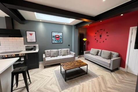 A modern, well-lit living room featuring stylis...