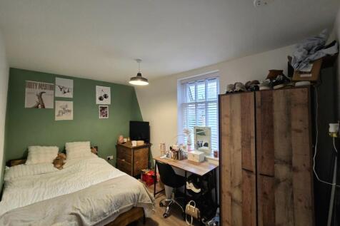 A cozy bedroom featuring a double bed and a war...