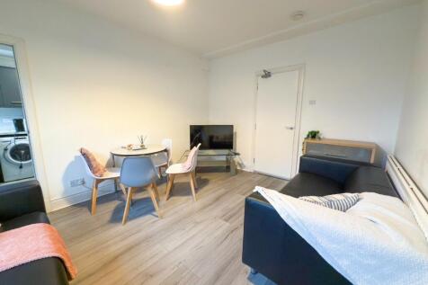 Bright and spacious living room featuring comfo...