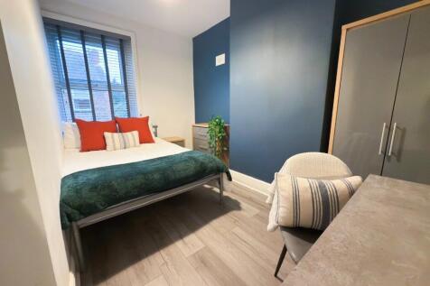 A modern, well-maintained bedroom featuring a d...