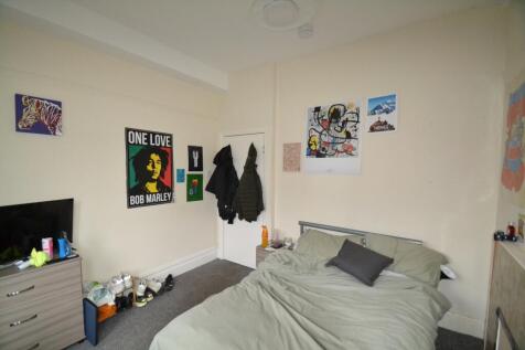 This inviting double bedroom features a comfort...