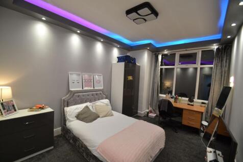 Stylish double bedroom with a plush upholstered...