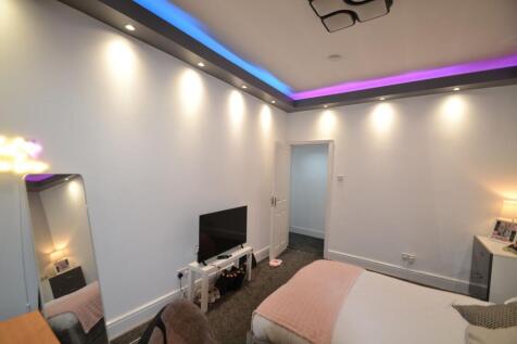 Bright, modern bedroom with recessed ceiling li...