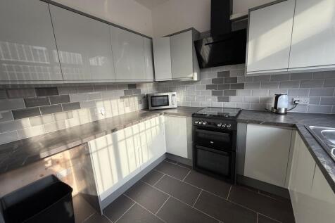 Bright, modern kitchen with sleek glossy cabine...