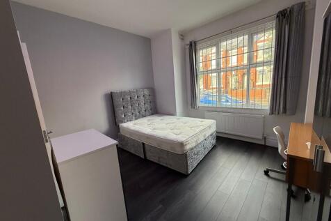 Bright, well-presented bedroom with a plush uph...