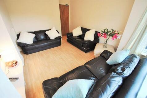 Bright, tidy living room with comfortable black...