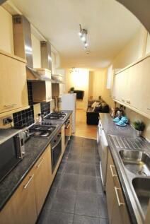 Long galley kitchen with modern appliances, dar...