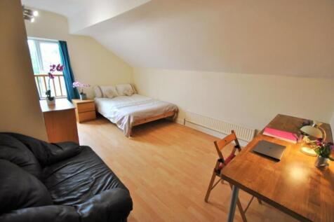 Bright attic-style double bedroom with sloped c...