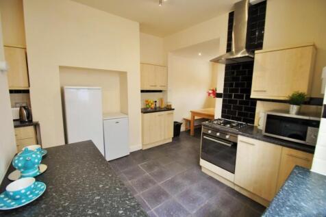 Bright, modern kitchen with integrated oven, am...