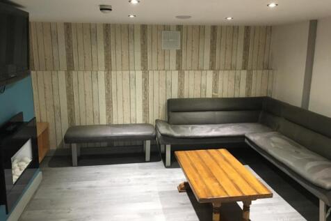 Contemporary lounge with wrap-around grey seati...