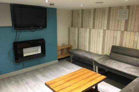 Comfortable communal lounge with modern wall-mo...