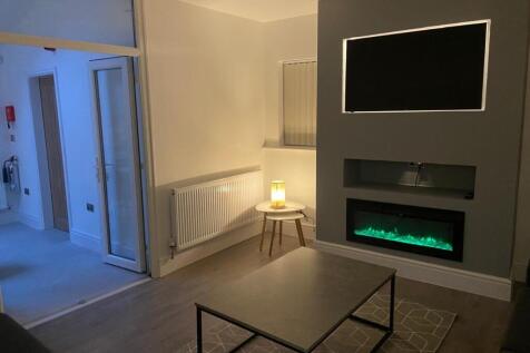 Contemporary living room with a modern inset el...