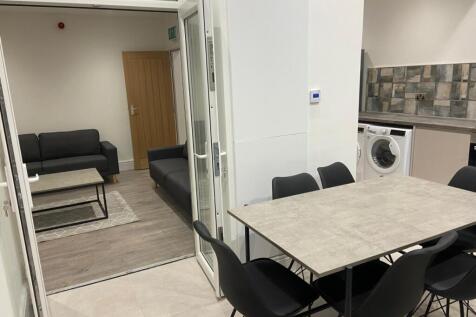 Modern communal lounge with a dining table and ...