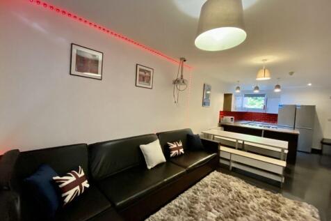 Modern open-plan living area with a black leath...