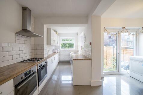 Bright modern kitchen with integrated appliance...