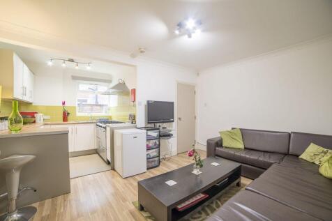 Bright, open-plan living area with a modern kit...