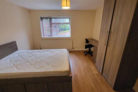 A comfortable bedroom featuring a double bed an...