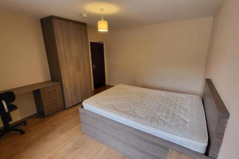 A neatly maintained bedroom featuring a single ...