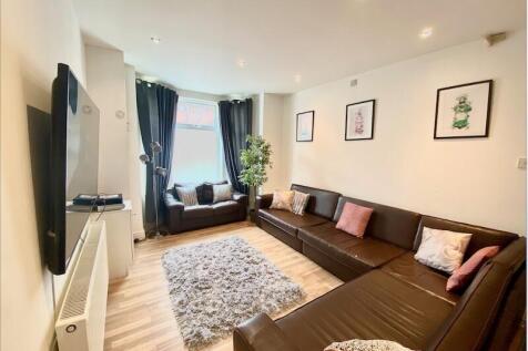 Contemporary living room with L-shaped leather ...