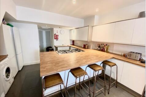 Bright modern kitchen with a central breakfast ...