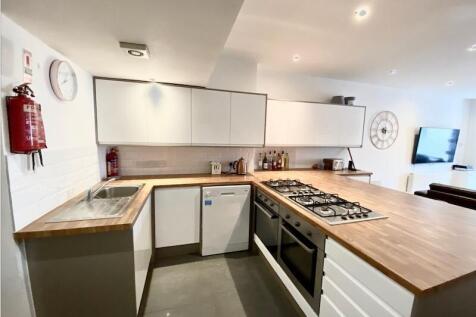 Bright modern kitchen with wood-effect worktops...