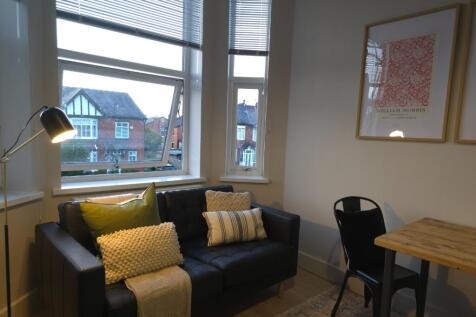 Bright, cosy living area with a comfortable two...