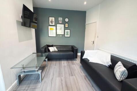 Modern furnished living room with two black sof...