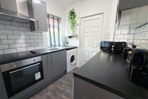 Modern galley kitchen with grey cabinetry, inte...