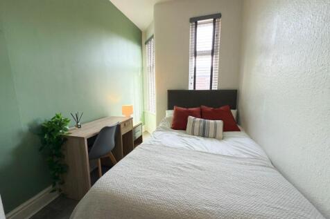 Bright, tidy bedroom with a comfortable bed, si...