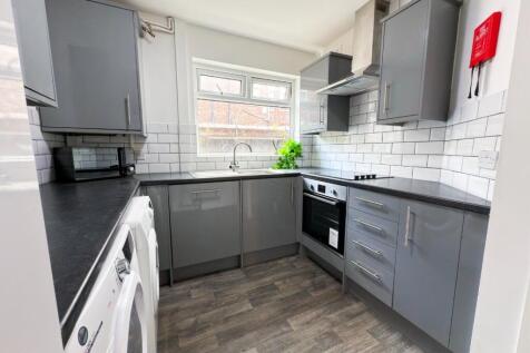 Bright modern kitchen with grey cabinetry, inte...
