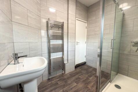 Modern bathroom with large walk-in shower, pede...