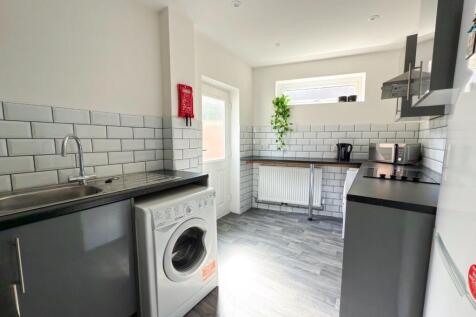 Bright modern kitchen with white subway tile sp...