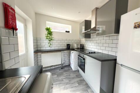 Bright modern kitchen with slate-coloured workt...