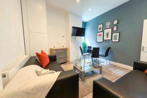 Bright, modern living room with comfortable bla...