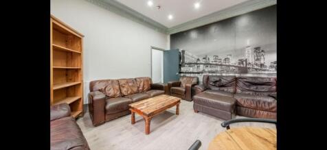 Comfortable communal lounge with multiple leath...