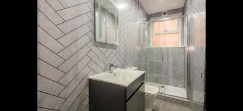 Contemporary bathroom with a sleek vanity unit,...