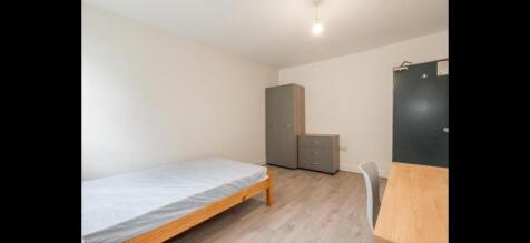 Neat, simply furnished bedroom with a single be...