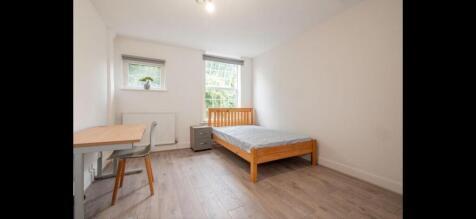 Bright, simply furnished double bedroom with a ...