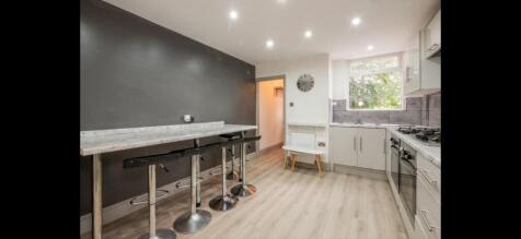 Bright modern kitchen with a breakfast bar and ...