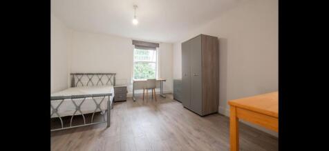Bright, tidy double bedroom featuring a metal-f...