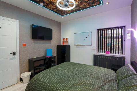 A stylish double bedroom with modern decor, per...