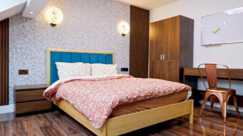 A bright and inviting double bedroom featuring ...