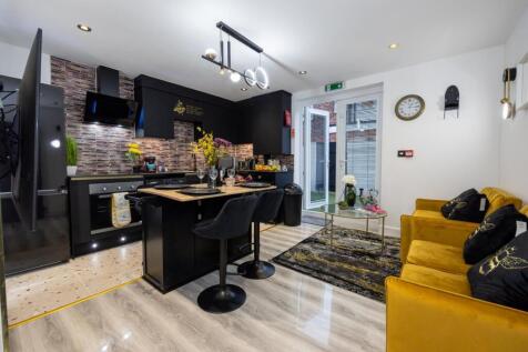 A stylish and modern kitchen with ample space a...