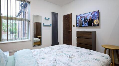 A bright and inviting double bedroom featuring ...