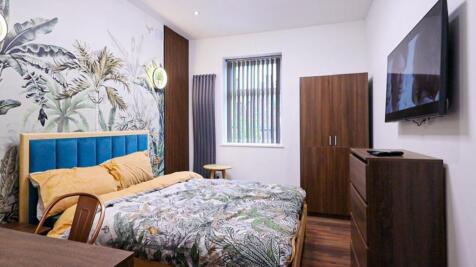 A stylish and inviting double bedroom featuring...