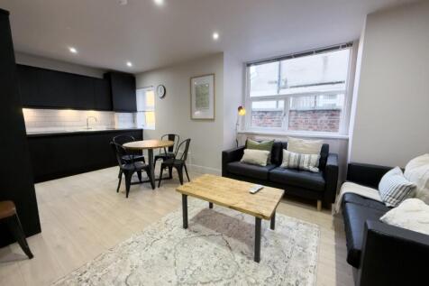 Bright, modern open-plan living area with a com...