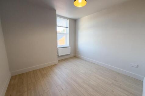 Bright, freshly painted single bedroom with a l...