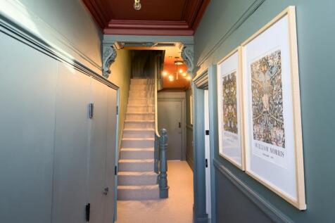Bright, well-decorated hallway with high ceilin...