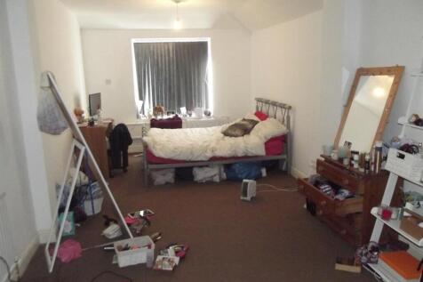 Bright bedroom with a double bed, full-length m...