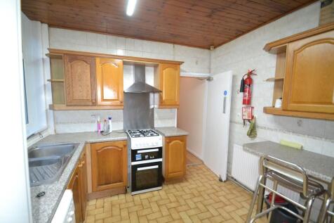 A well-maintained kitchen with wooden cabinets,...